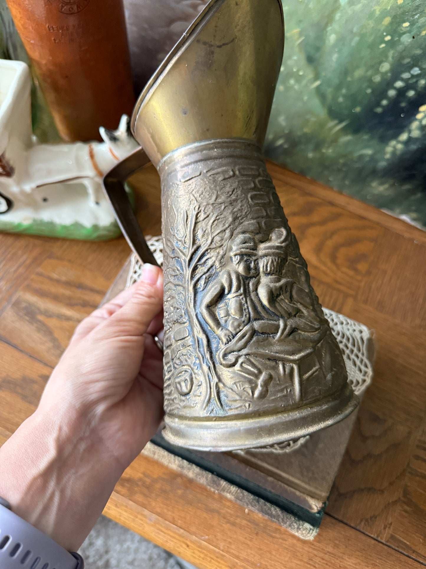 Brass pitcher with embossed colonial scene