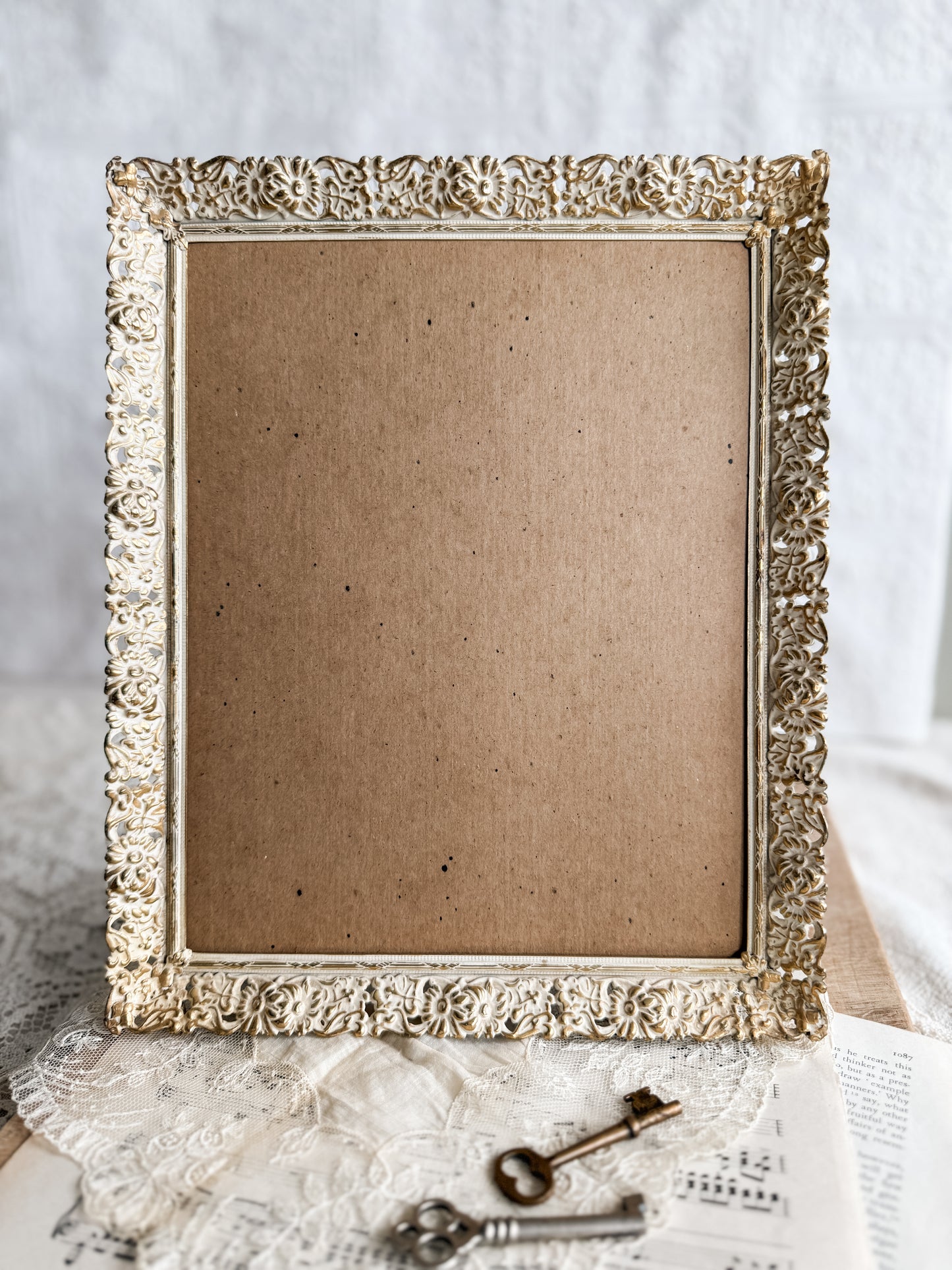 Large gold and white floral filigree frame