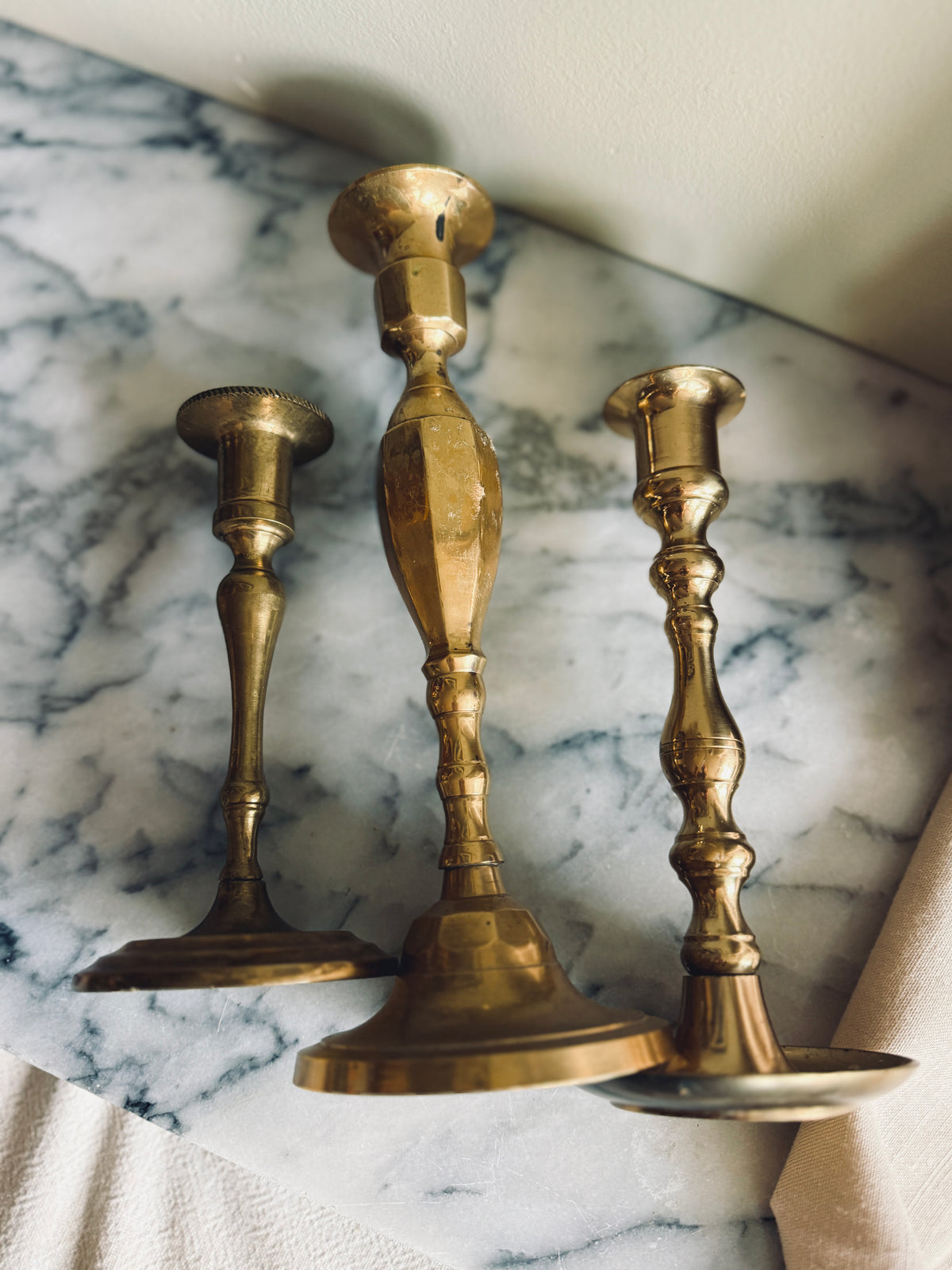 Instant collection of three vintage solid brass candlesticks
