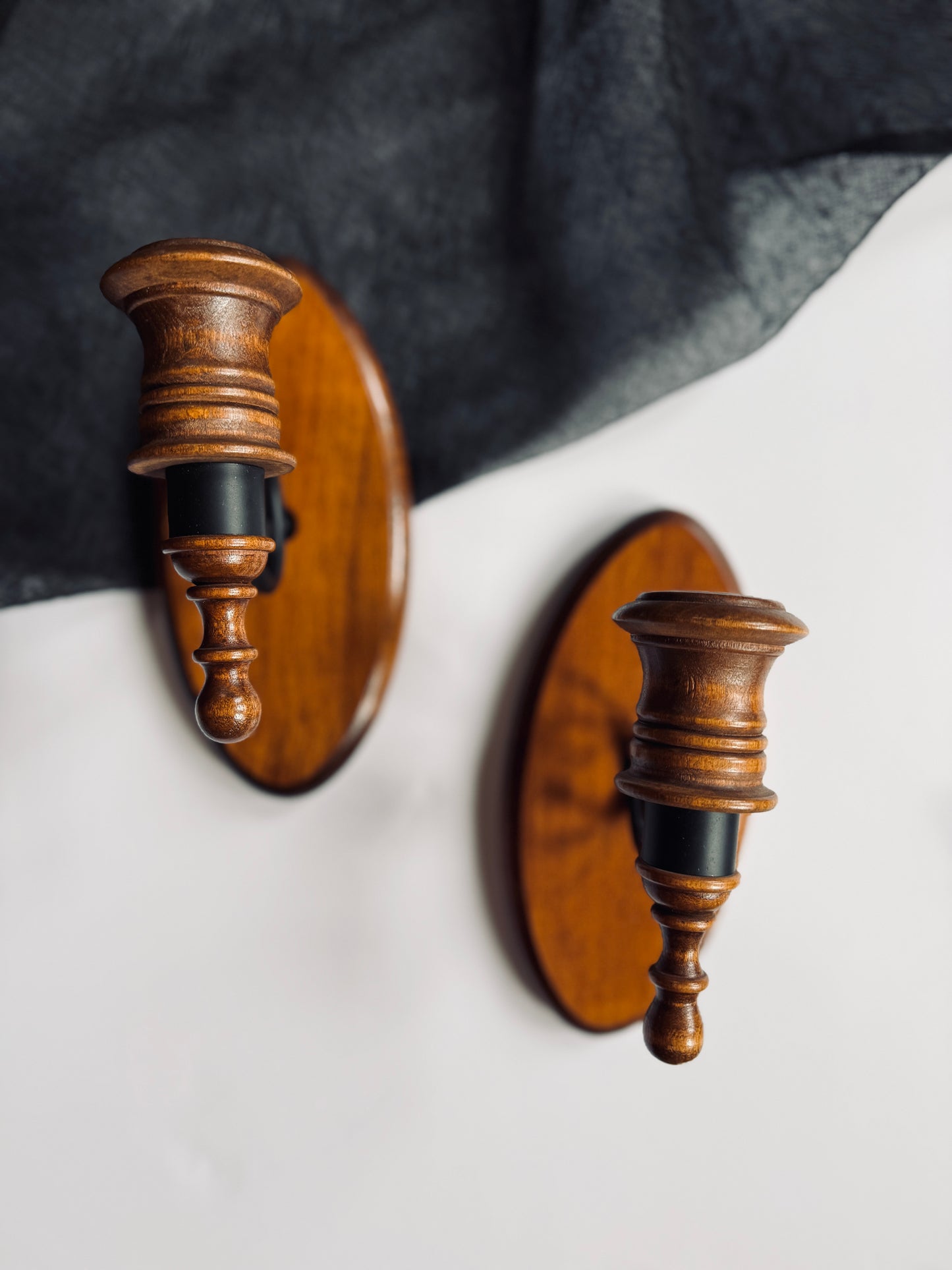 Pair of black metal and wood wall sconces