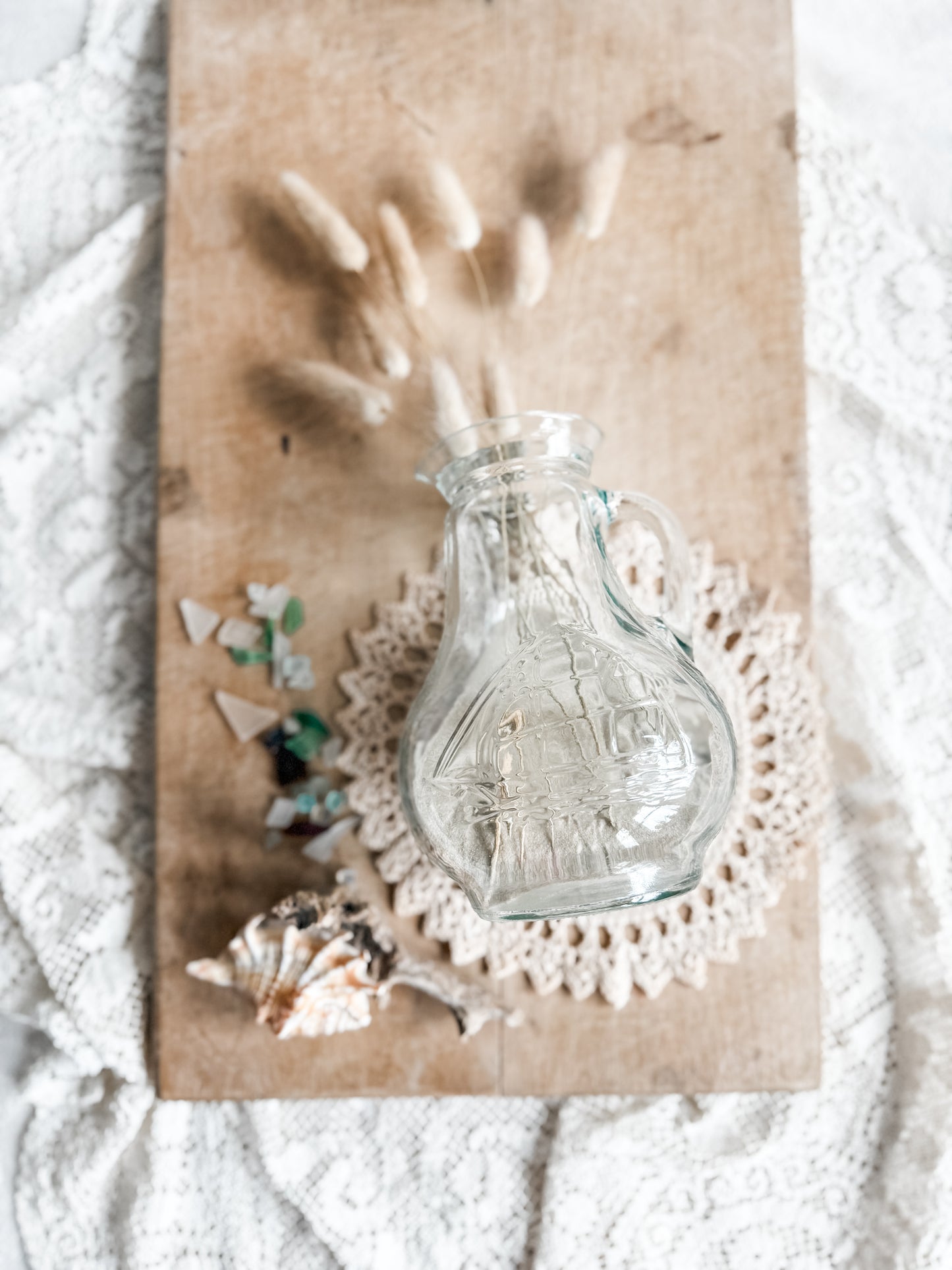 Glass pitcher with embossed sailing ship