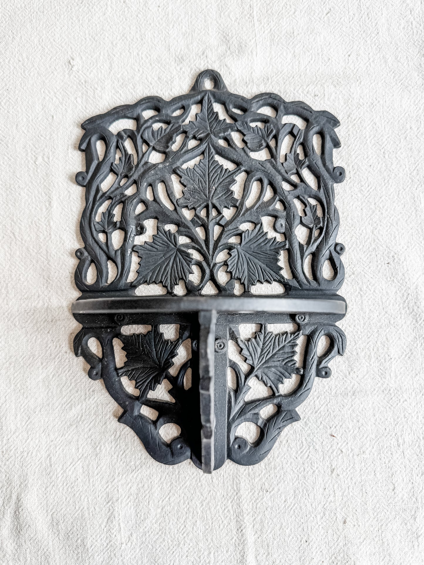 Cast iron wall shelf with leaf motif