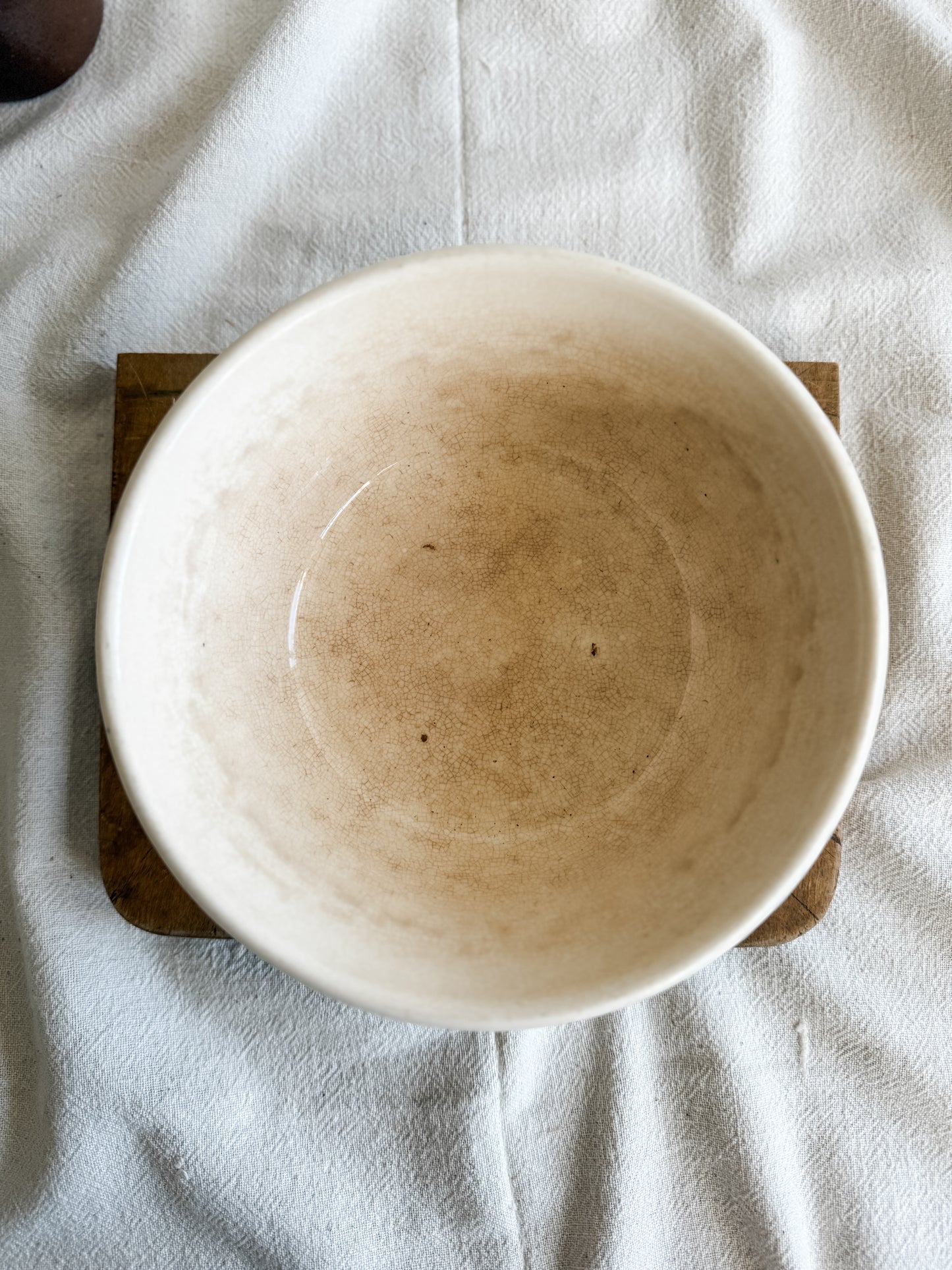 Stained and crazed antique bowl with teal stripe.