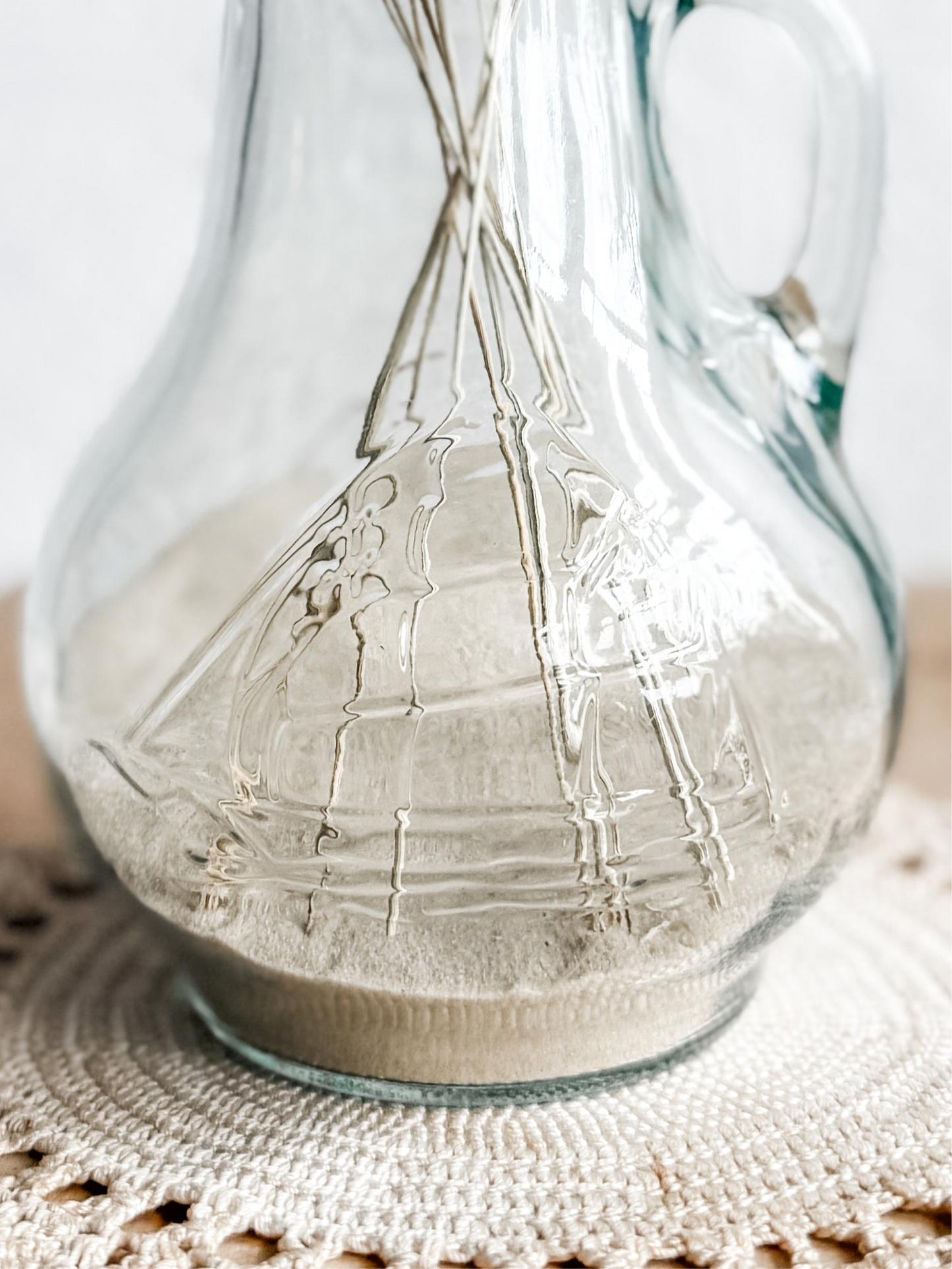 Glass pitcher with embossed sailing ship