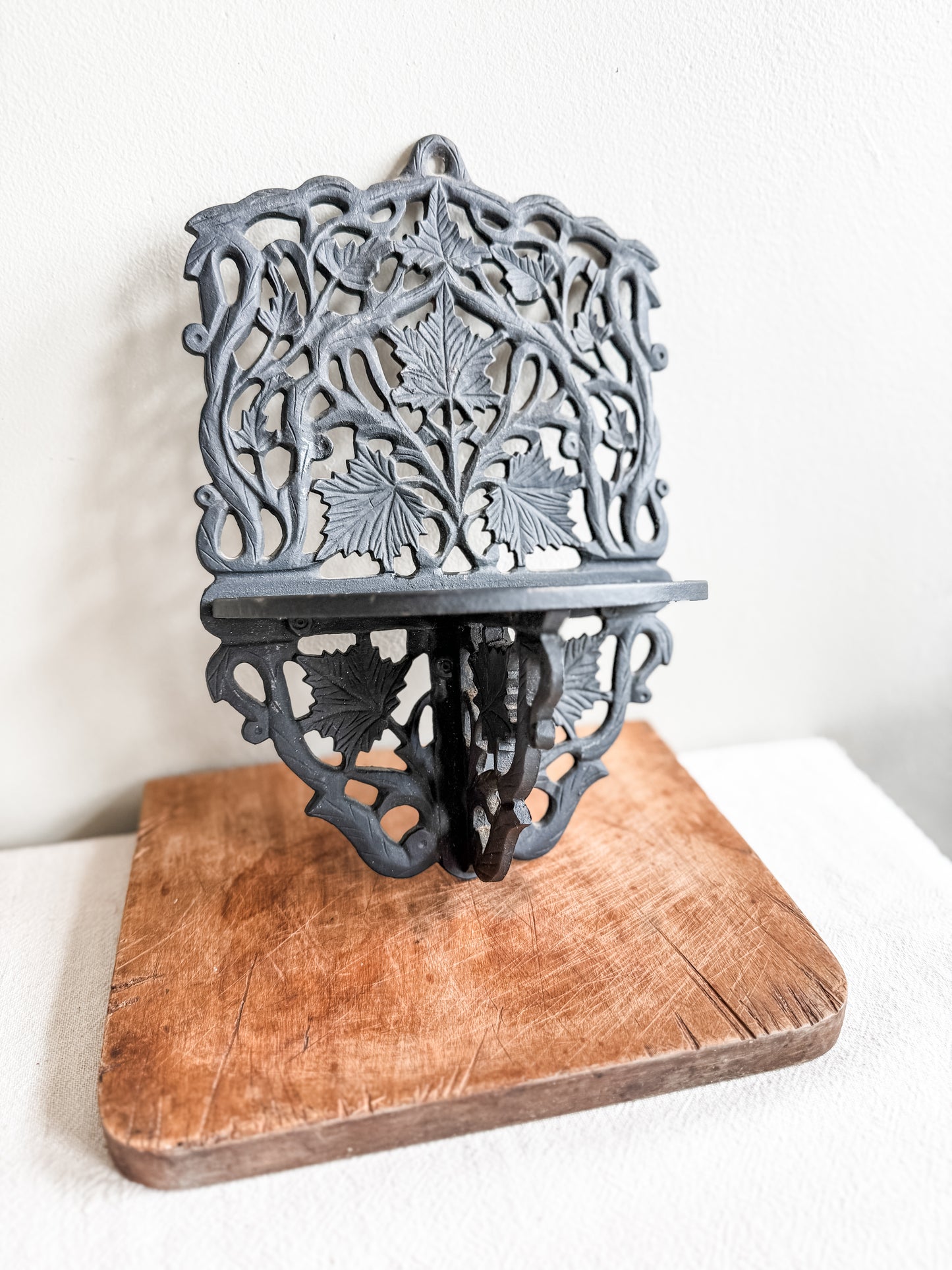 Cast iron wall shelf with leaf motif