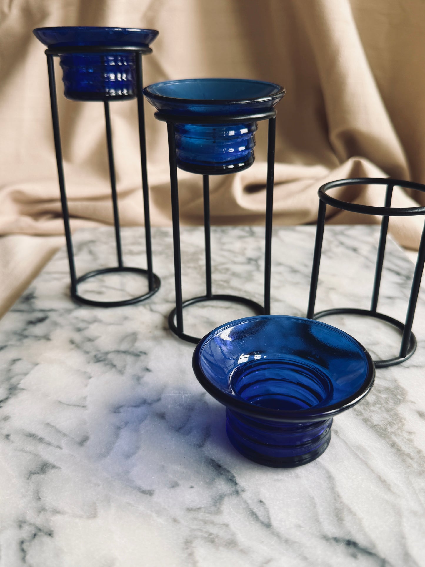 Metal and cobalt blue glass tealight holders