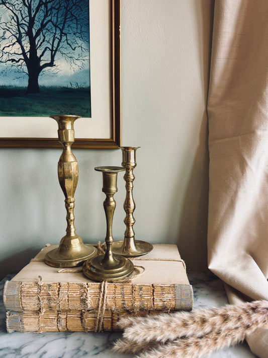 Instant collection of three vintage solid brass candlesticks