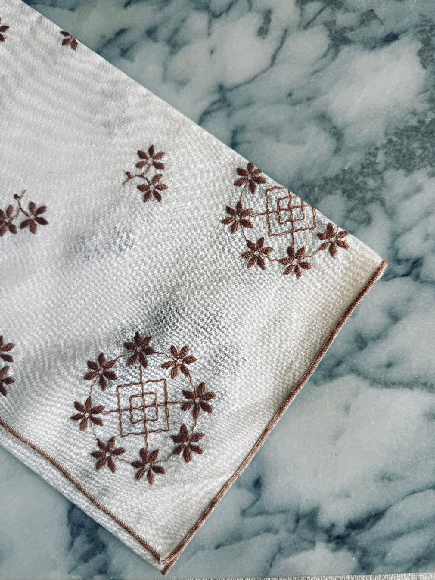 White and brown embroidered linen