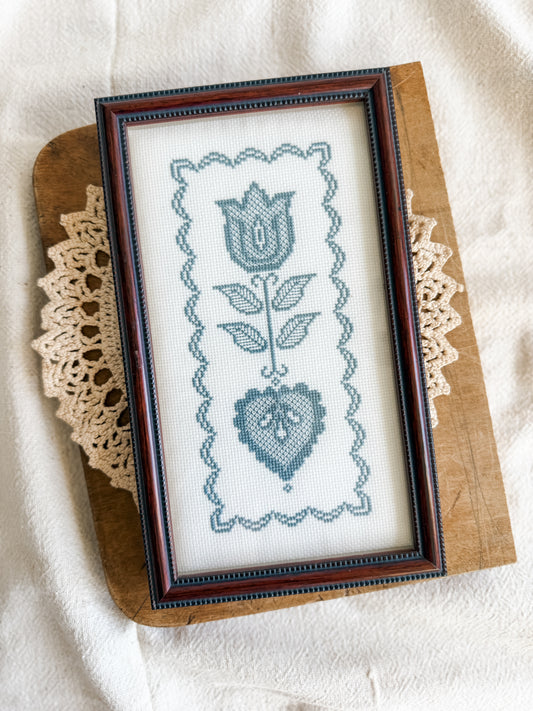 Framed blue and white cross stitch