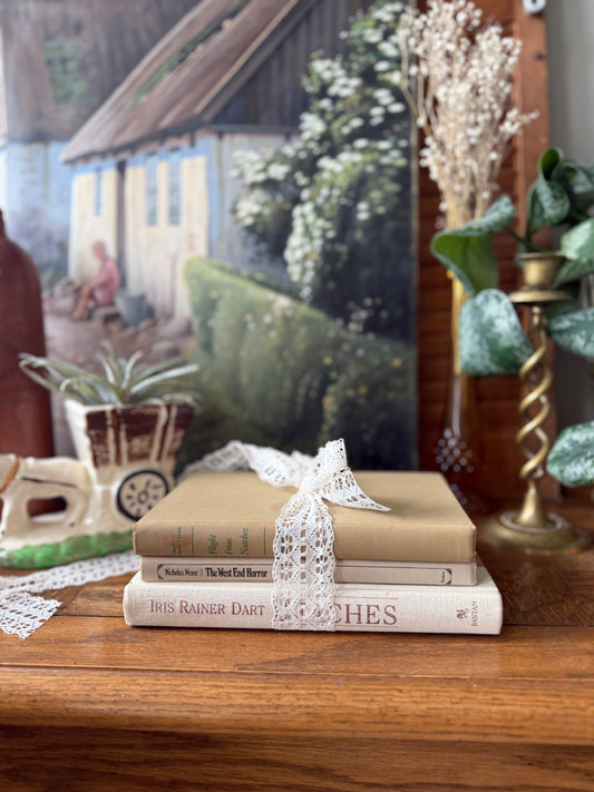 Neutral book stack tied with lace ribbon