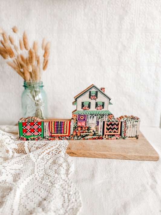 Wooden Farmhouse with hanging quilts on the line