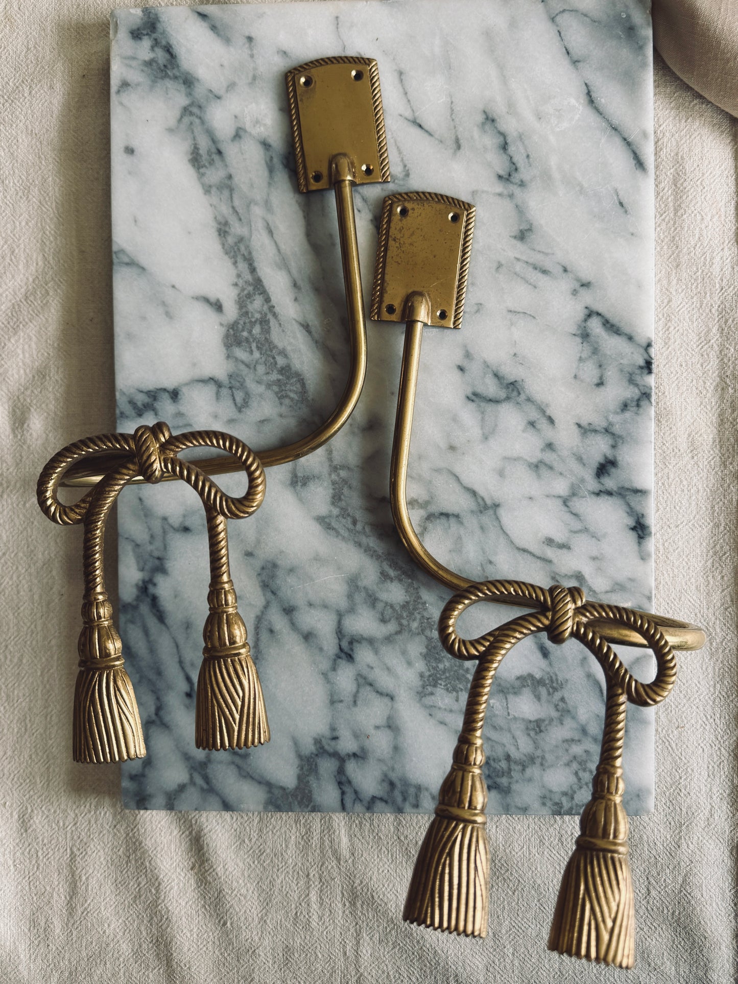 Pair of brass bow curtain tie backs