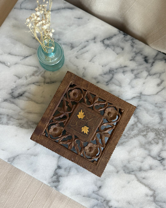 Hand carved wooden trivet with brass floral inlay