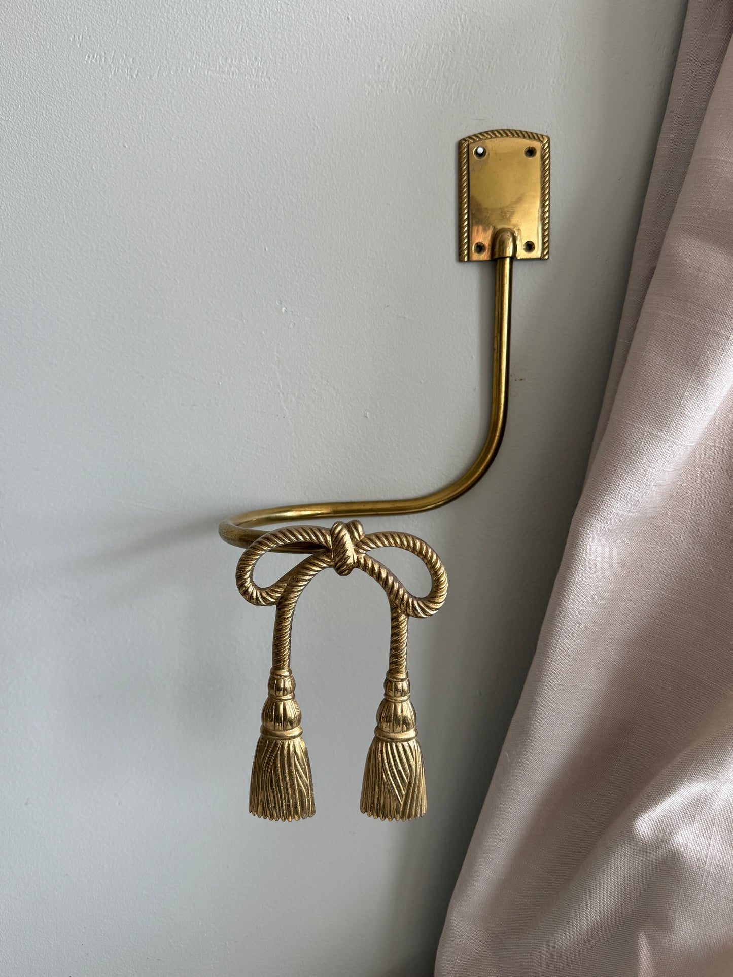 Pair of brass bow curtain tie backs