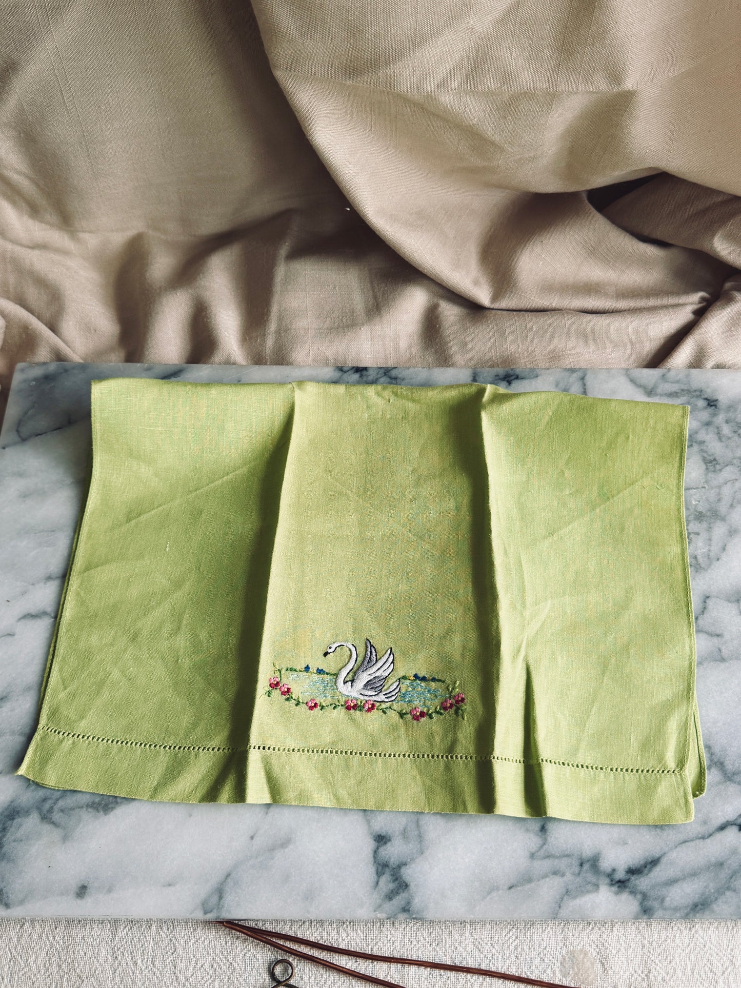 Green linen towel with embroidered swan