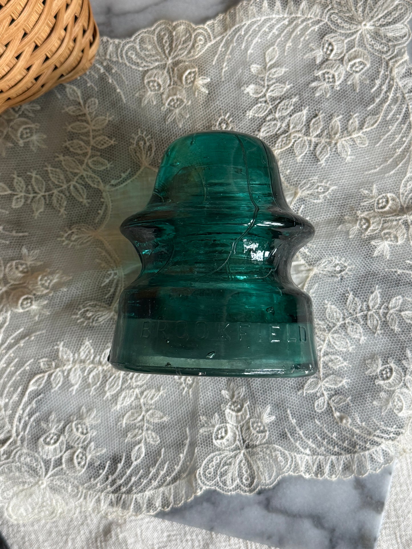 Teal colored glass insulator