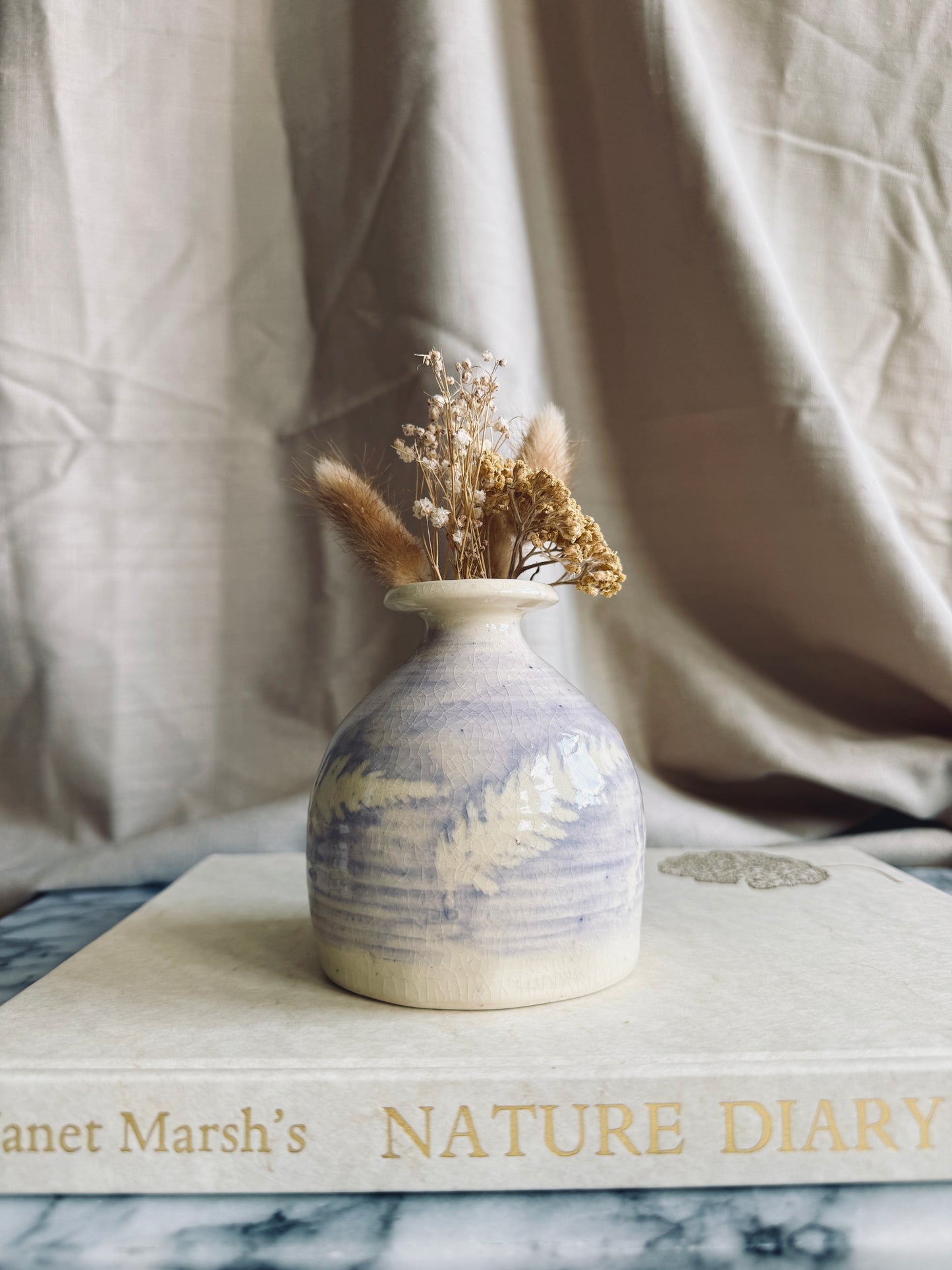 Studio pottery bud vase with purple glaze and fern design