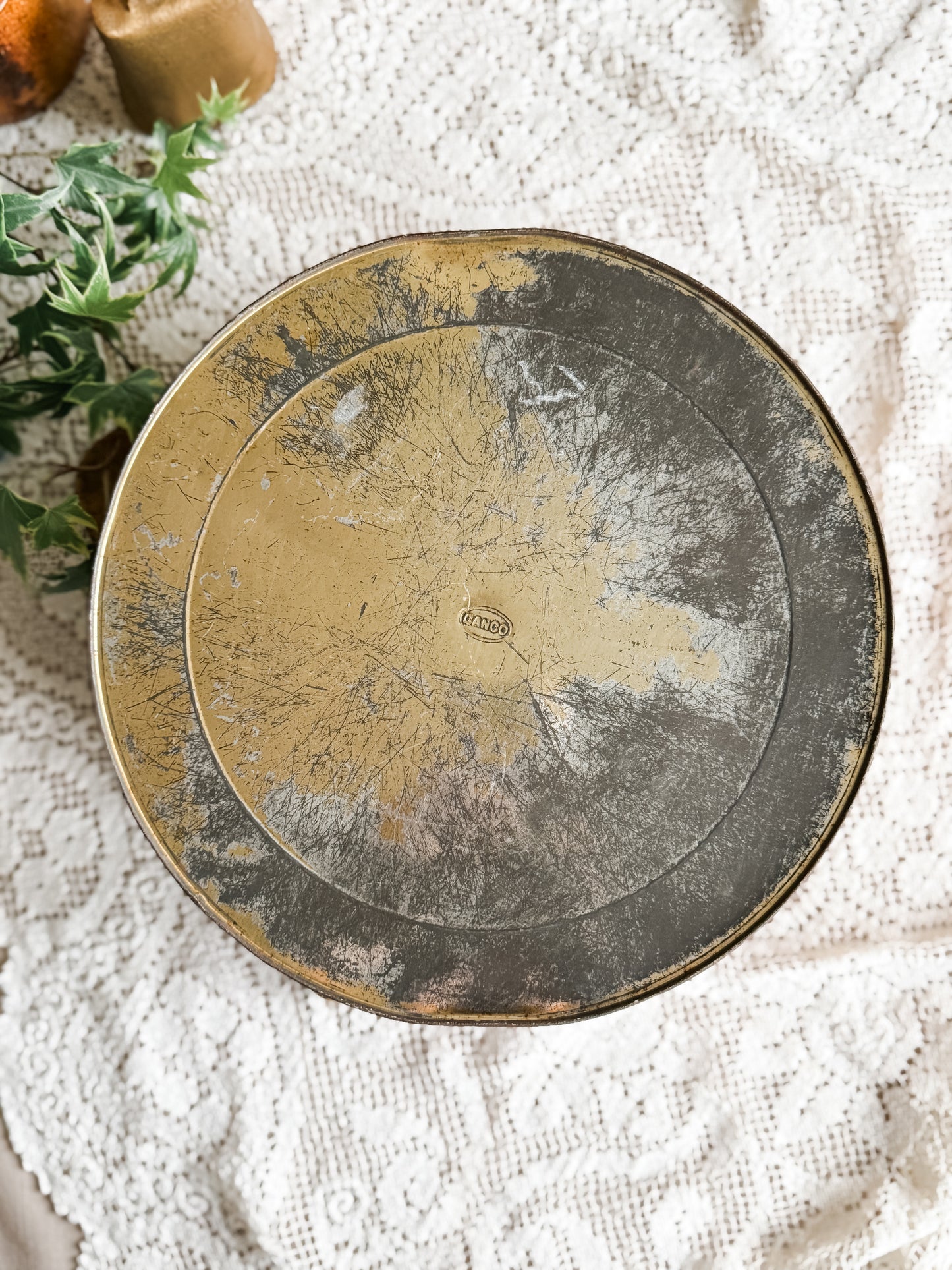 Large weathered orange tin with courting scene