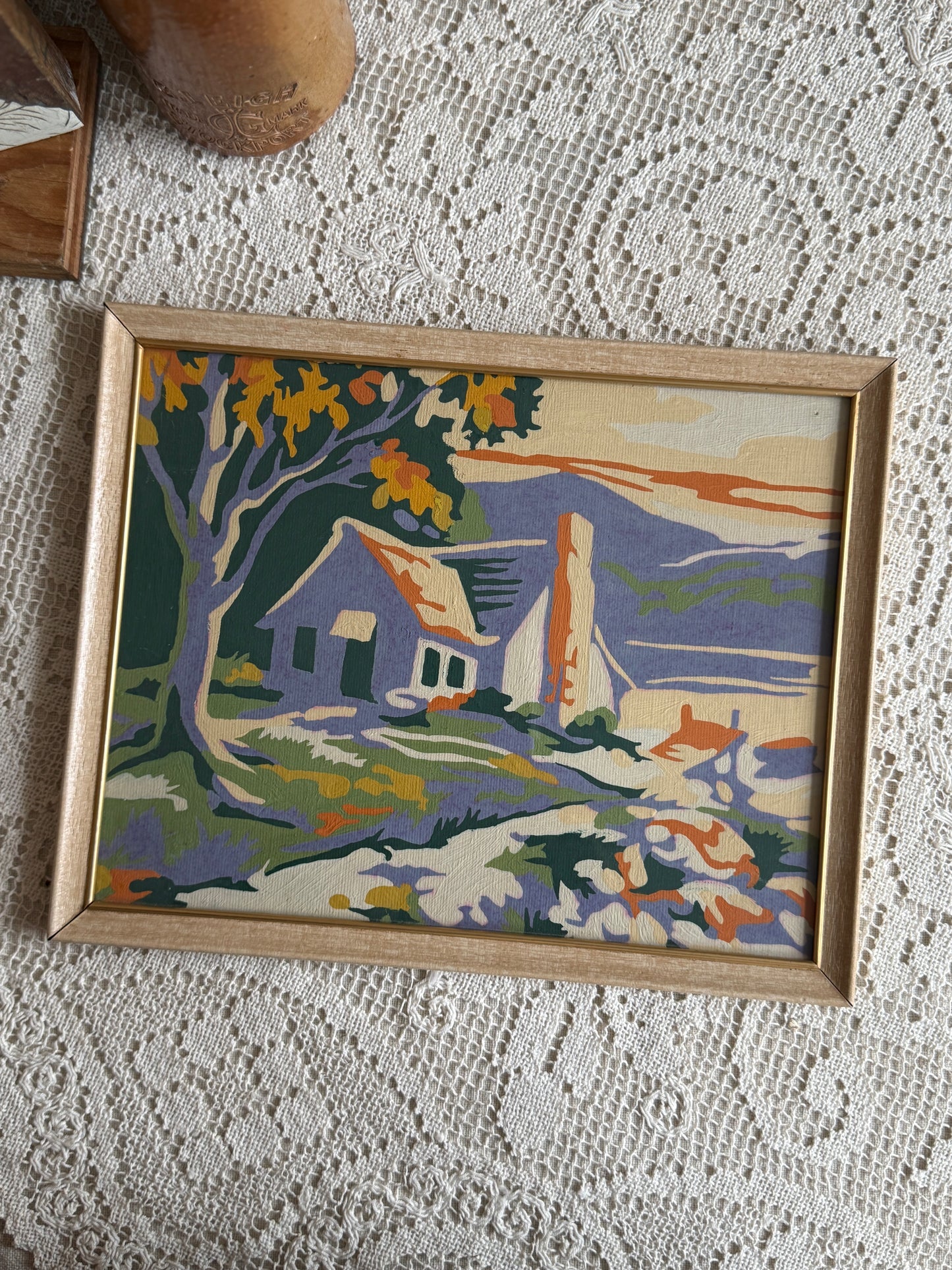 Framed paint by number of a cottage