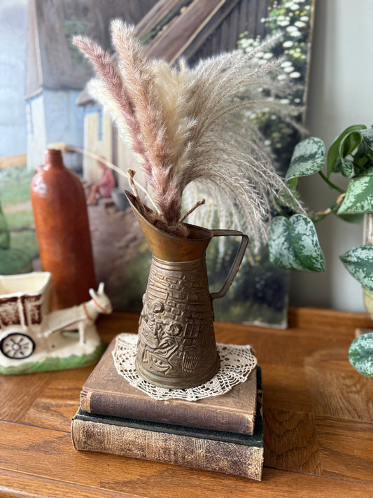 Brass pitcher with embossed colonial scene