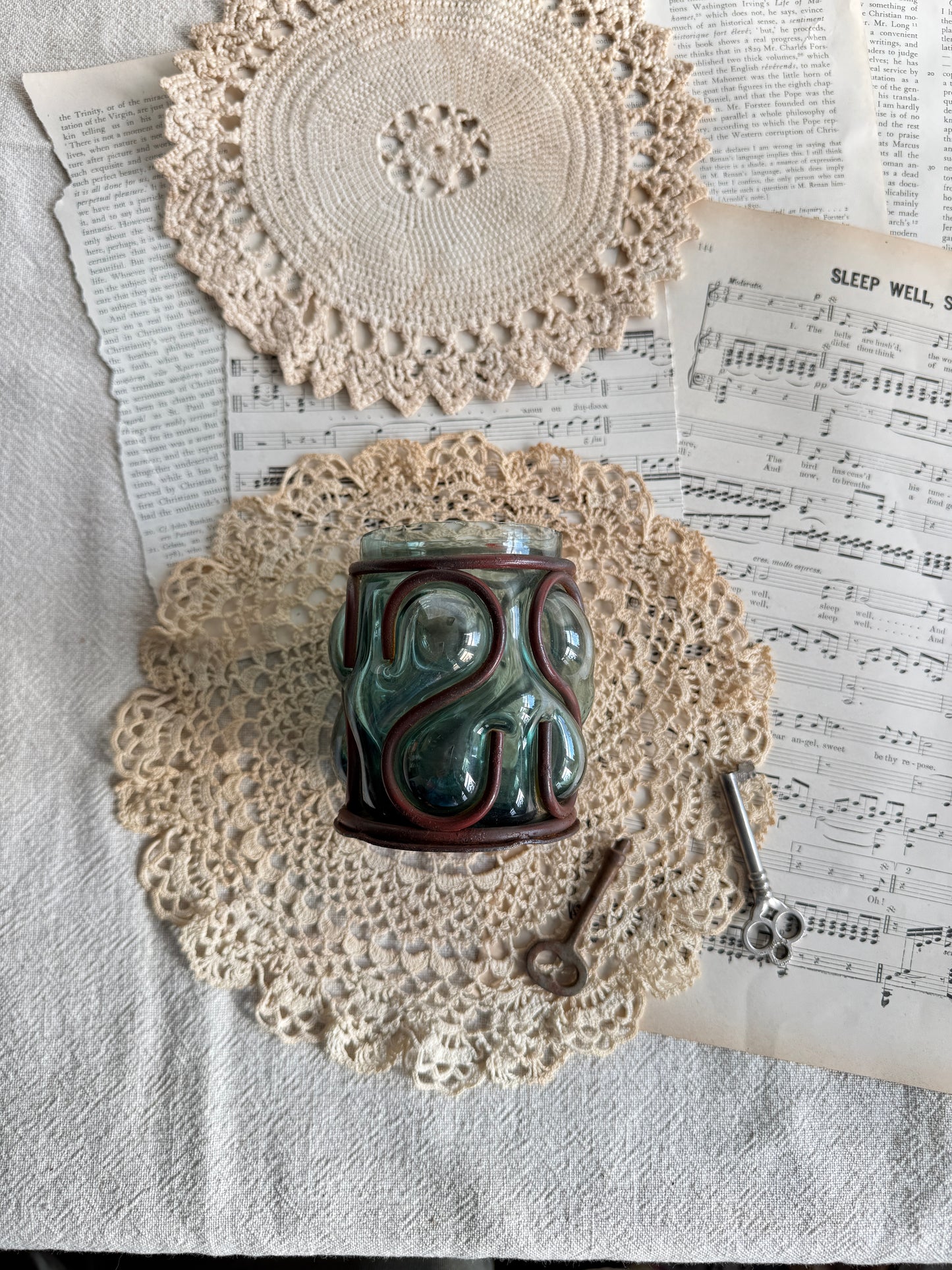 Caged glass candle holder