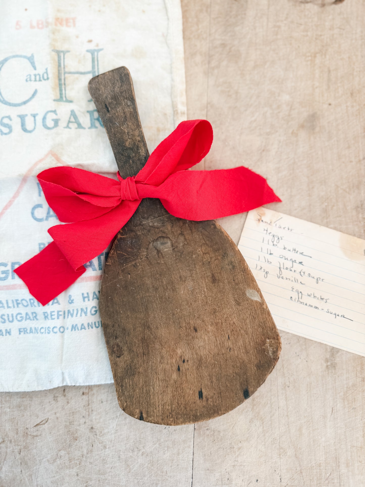 Primitive butter paddle with ribbon