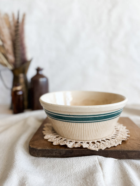 Stained and crazed antique bowl with teal stripe.