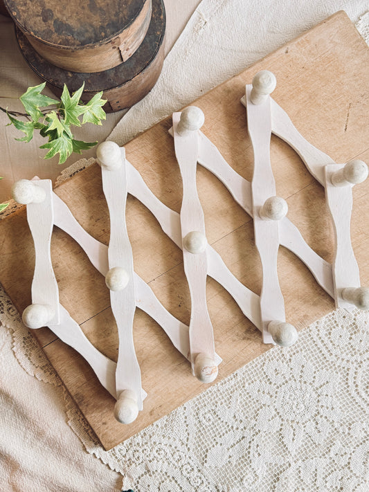 White accordion peg rack