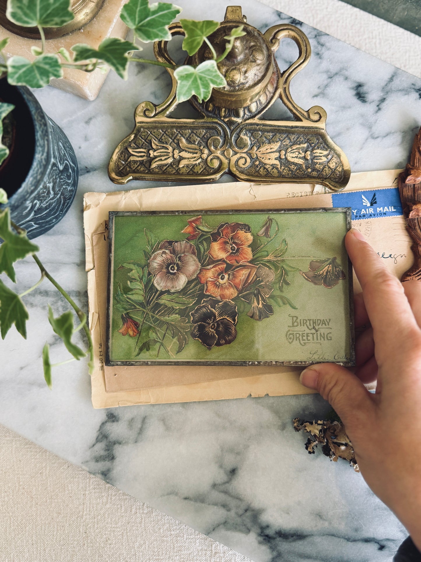 Antique postcard framed between glass