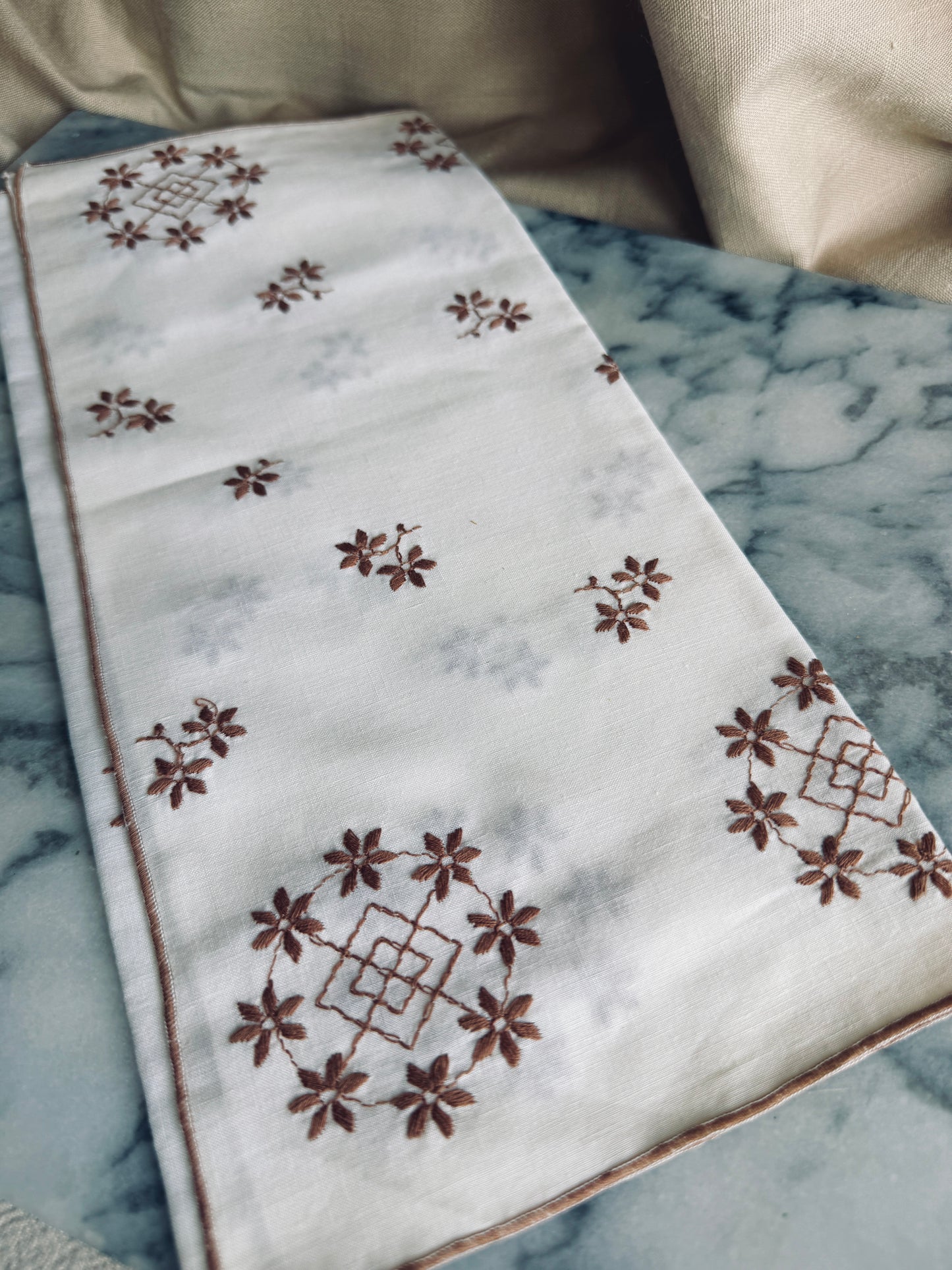 White and brown embroidered linen