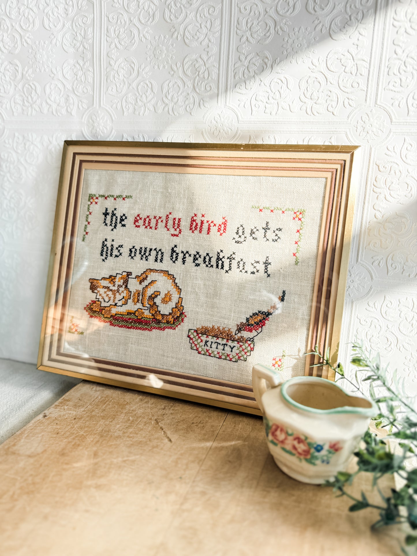 Matted and framed cross stitch “cat and bird”