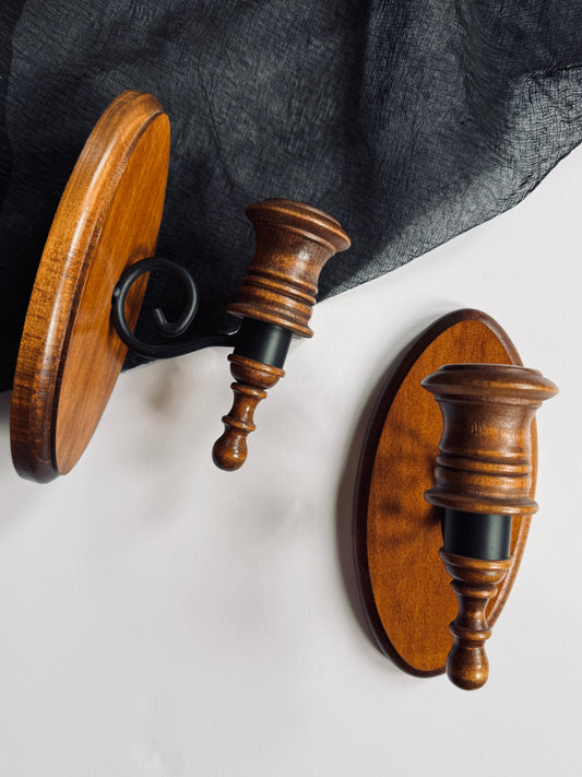 Pair of black metal and wood wall sconces