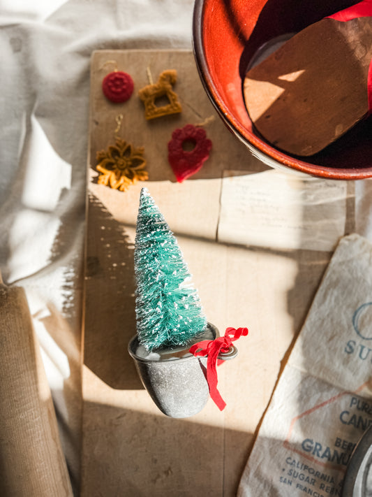 Bottle Brush tree in vintage measuring cup