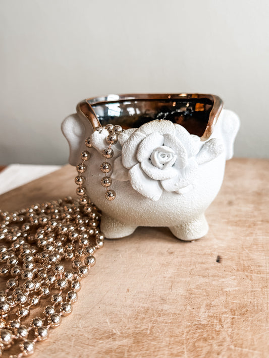 White planter with rose motif. Inside is brown glazed. 