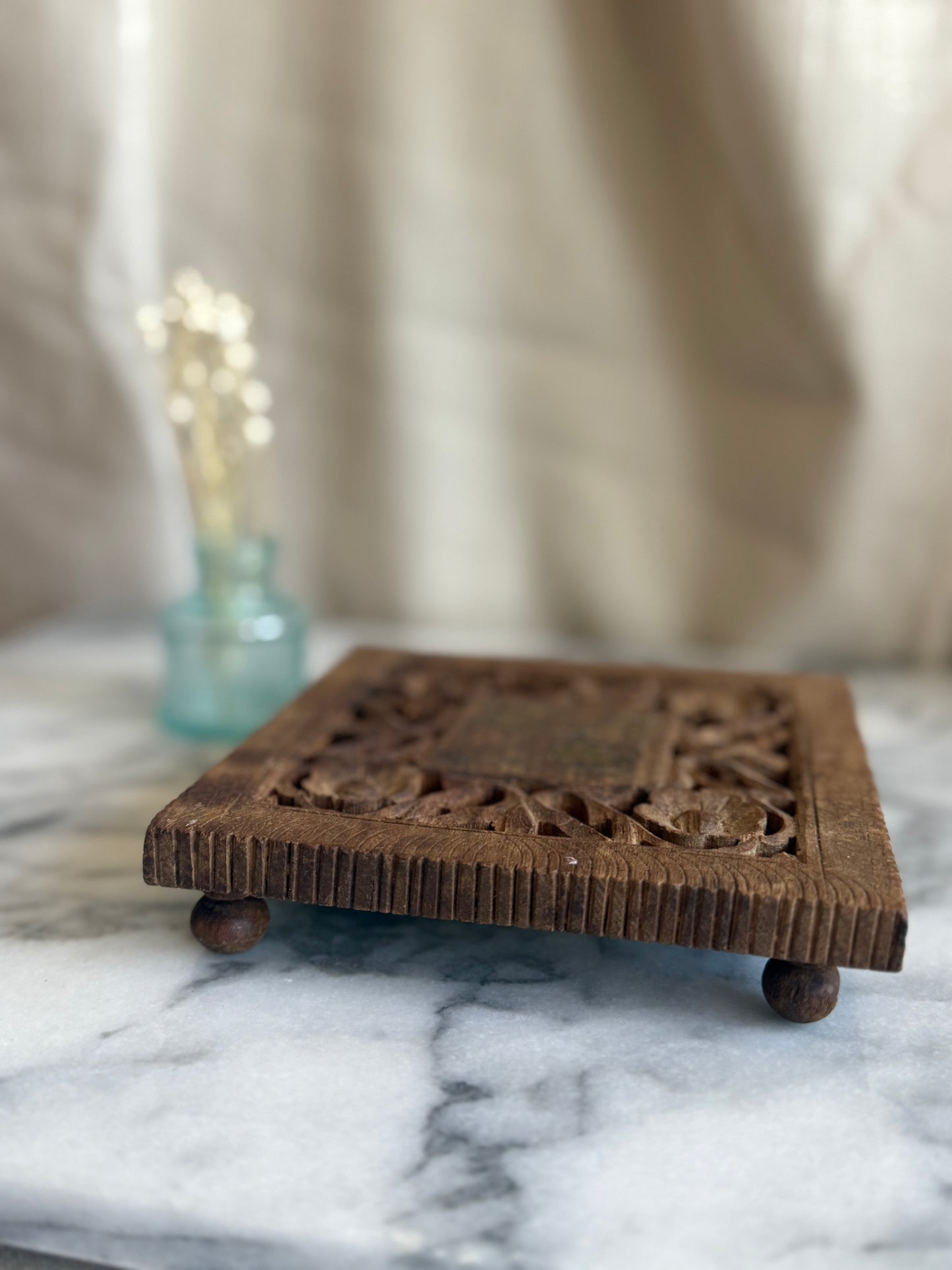Hand carved wooden trivet with brass floral inlay