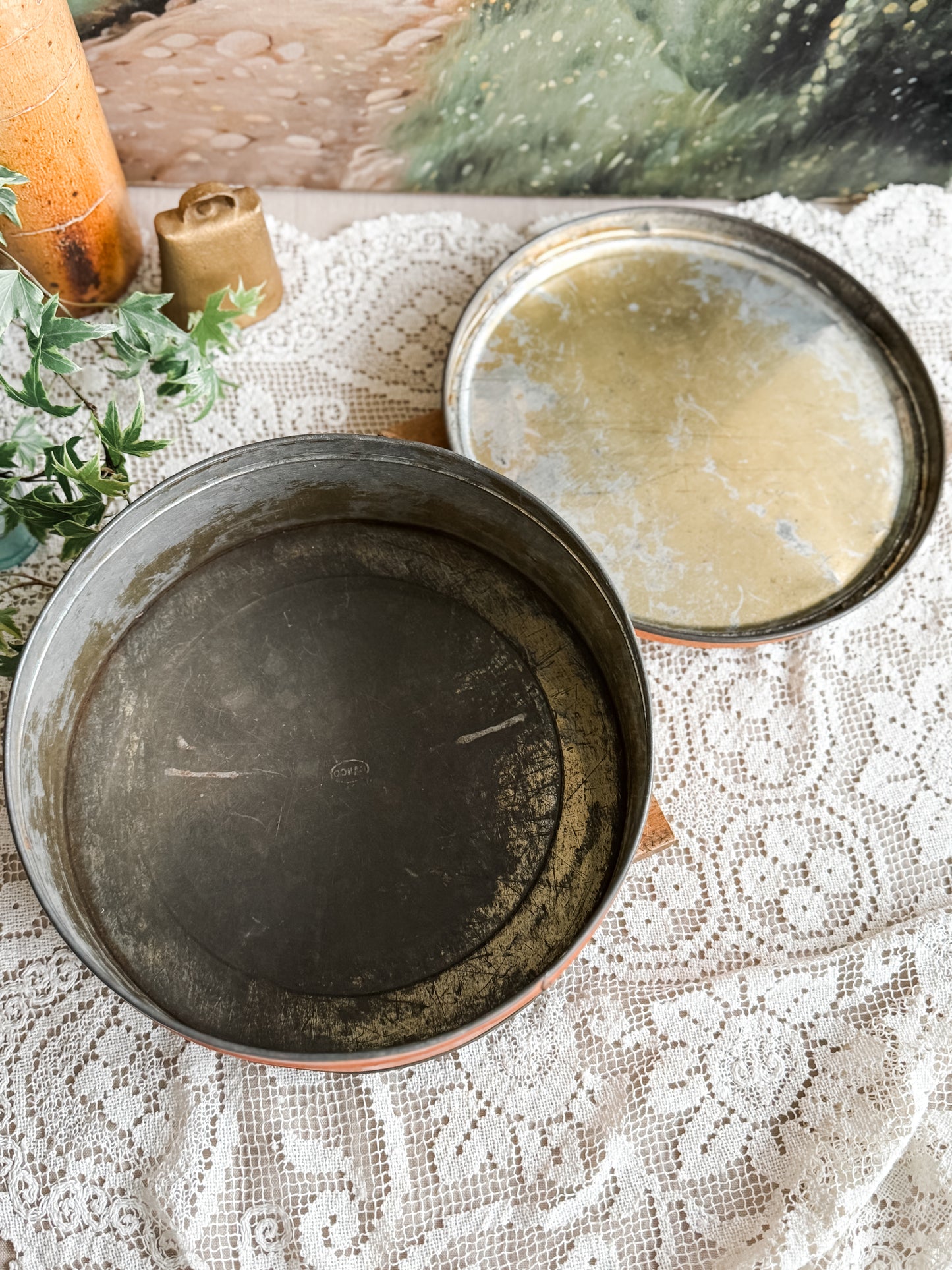 Large weathered orange tin with courting scene