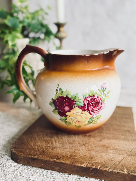 Antique porcelain pitcher with pink and yellow roses