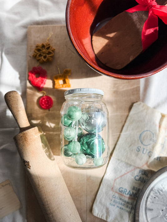 Vintage glass lidded jar with green ornaments