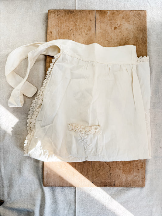 White vintage embroidered apron with crocheted trim