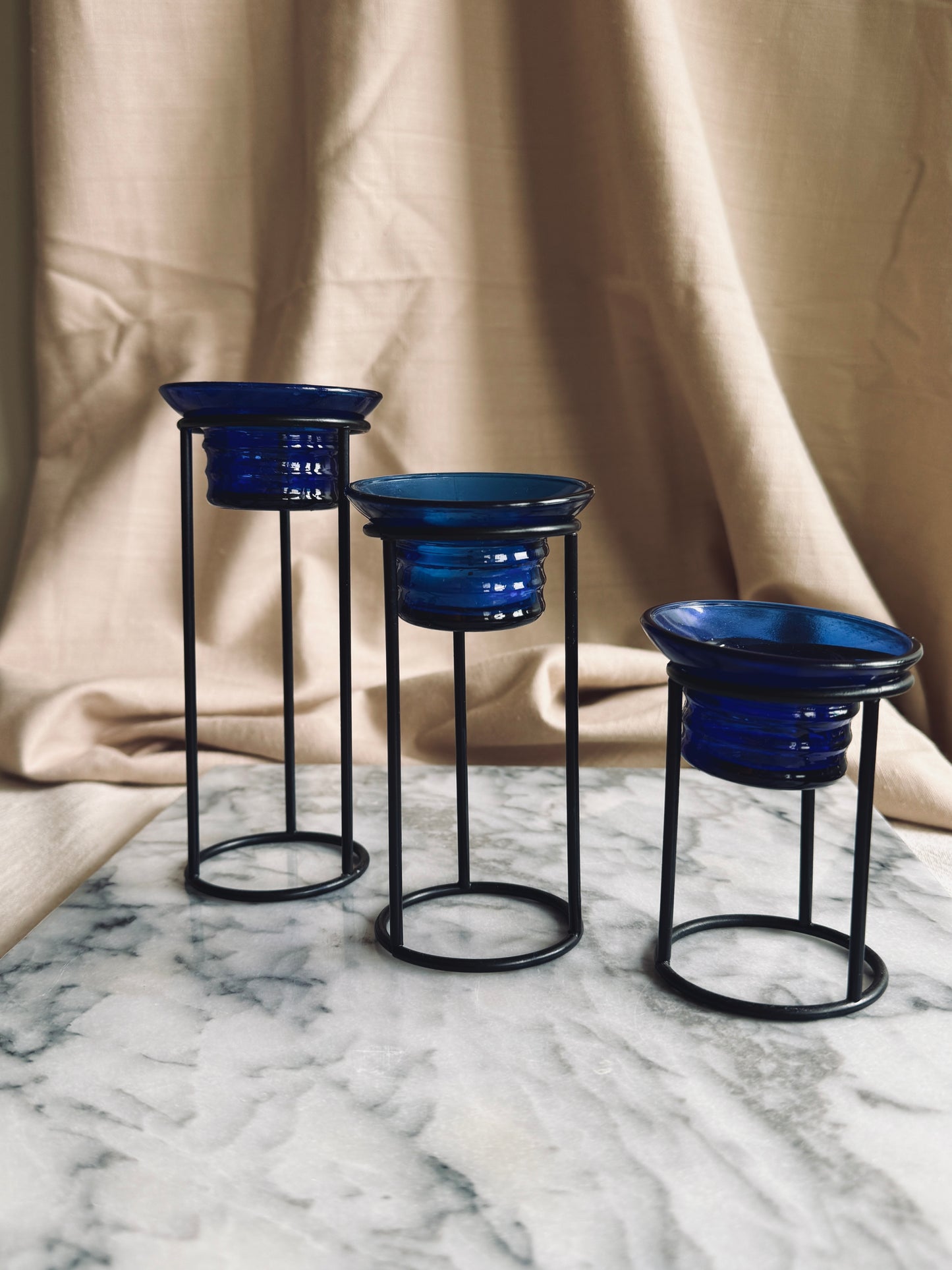 Metal and cobalt blue glass tealight holders