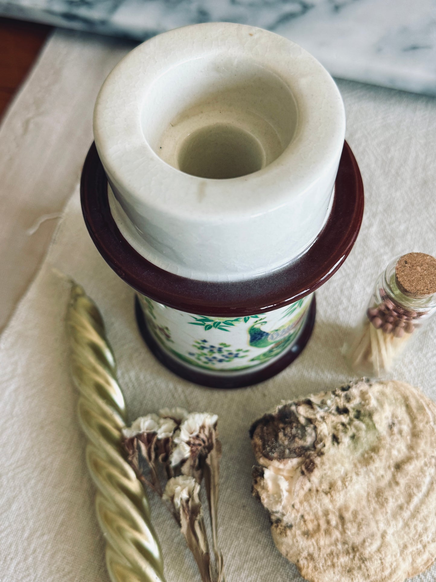 Porcelain candle holder with peacock