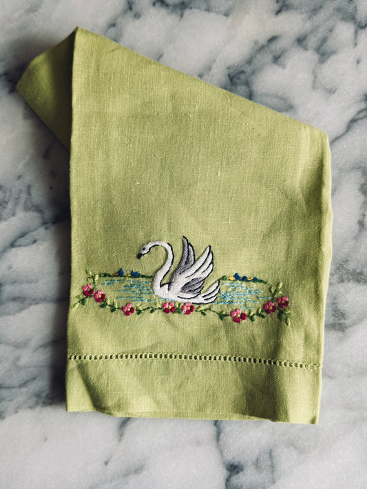 Green linen towel with embroidered swan