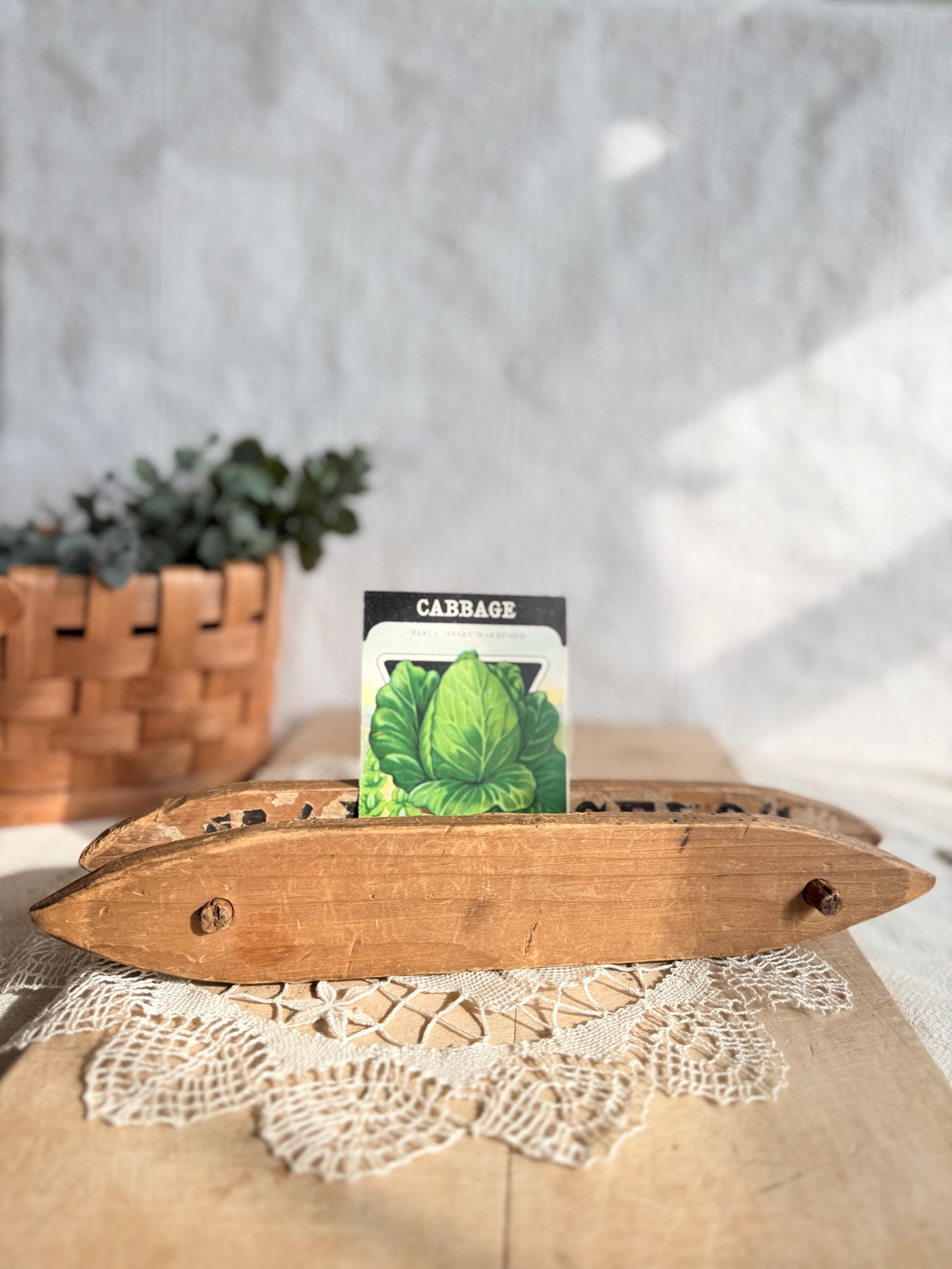 Primitive ribbon or twine holder made from an antique seed advertising box