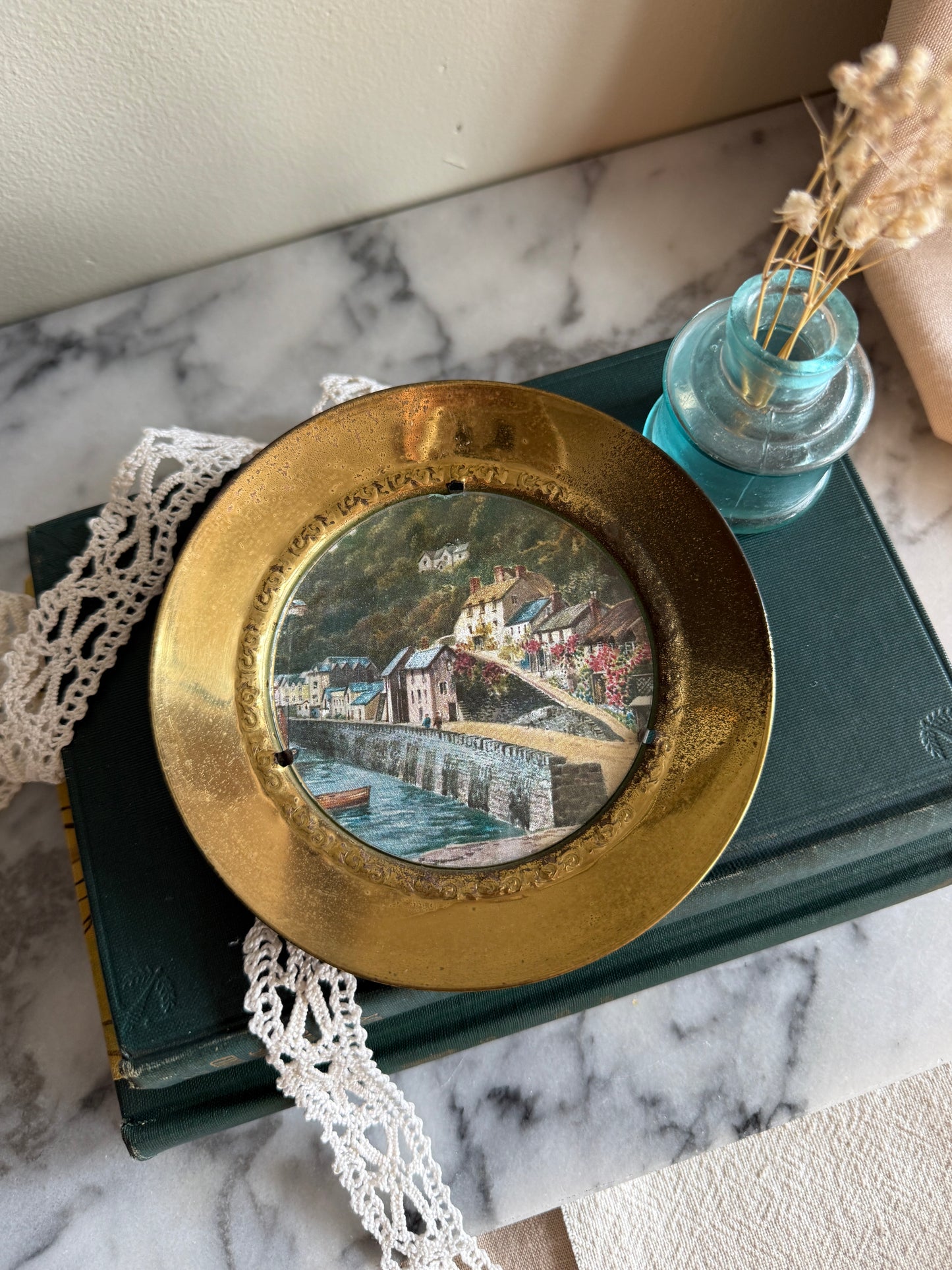 Brass wall plate with town scene