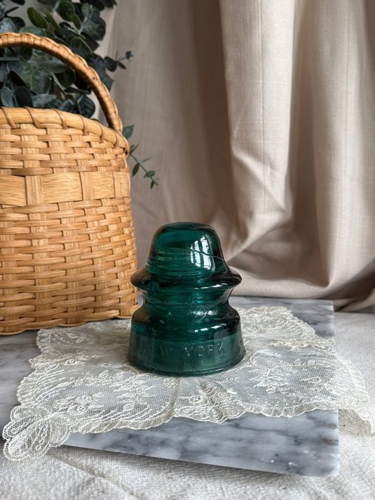 Teal colored glass insulator
